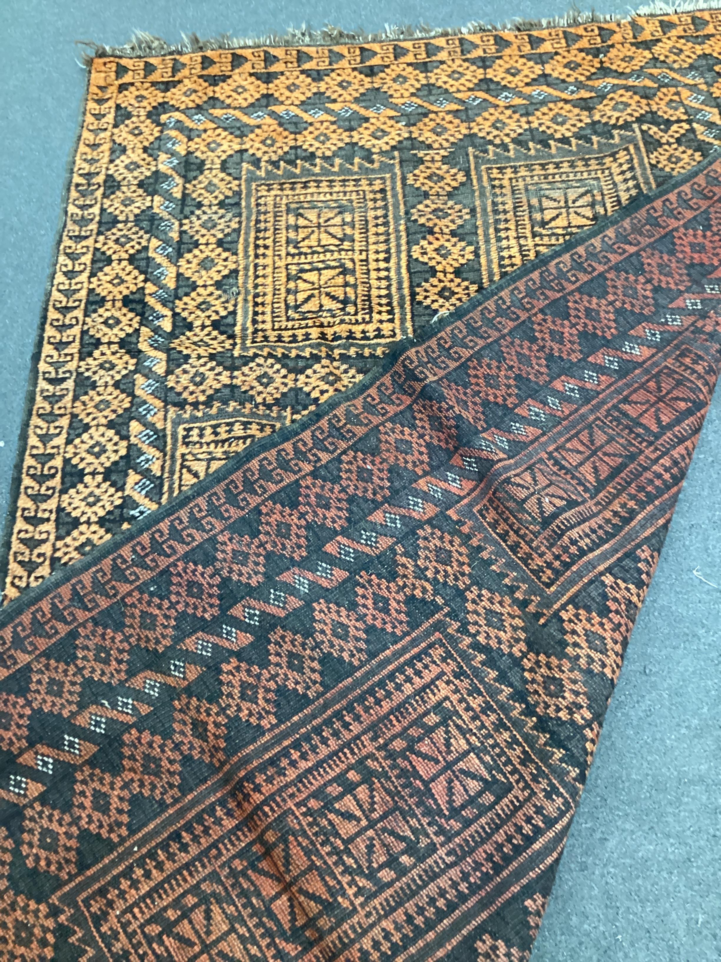 An Afghan geometric rug, 205cm x 138cm